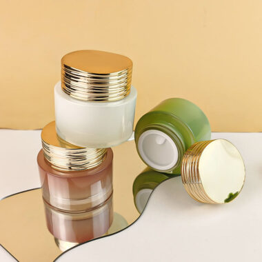 Frosted wide-mouth glass cosmetic jars with gold screw lids