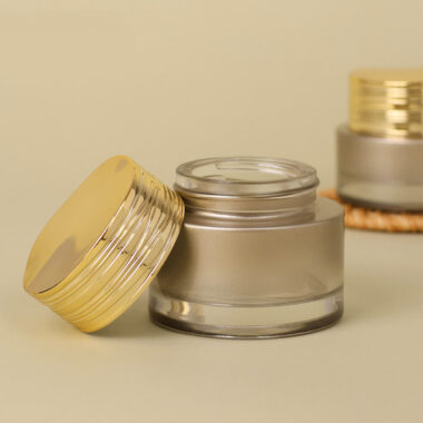 Frosted wide-mouth glass cosmetic jars with gold screw lids